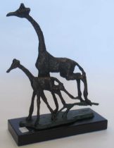 A bronzed metal model of two galloping giraffes, raised on plastic plinth base 30.5 x 23 x 9cm