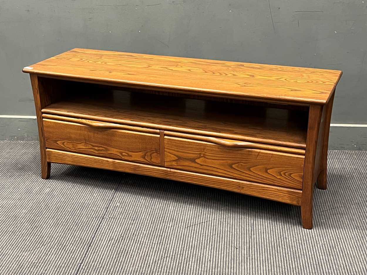 An Ercol stained elm sideboard 55 x 133 x 44cm