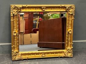 A rectangular gilt framed wall mirror, the bevelled plate within a moulded frame with acanthas