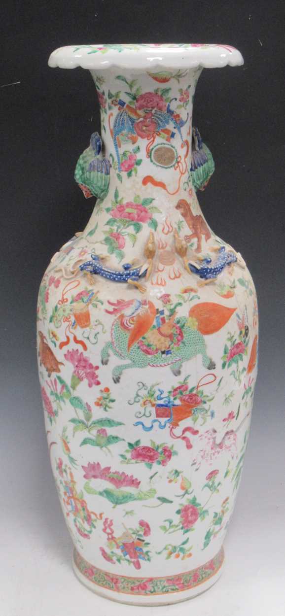 A large Chinese vase, the neck applied with dragons; a pair of Cantonese baluster vases and