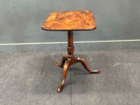 A 19th century mahogany tripod table, the rounded rectangular tilt-top on a turned column 68 x 69