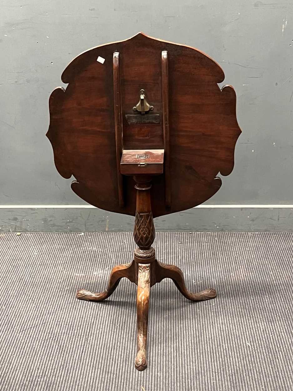 A mahogany snap top tripod table, with carved patterned shaped top on a baluster column and carved - Image 2 of 4