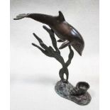 A bronze candle holder cast as a dolphin,