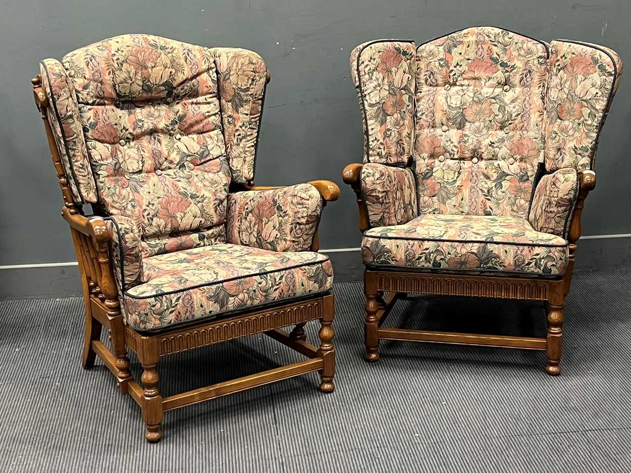 A pair of Ercol stained elm wing back armchairs (2)