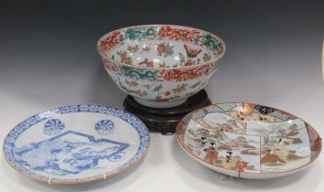 A modern Chinese punch bowl decoraqted with butterflies 36cm diameter, on a wooden stand, together