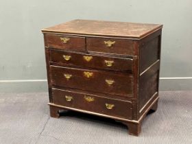 An early 18th century oak chest of drawers, comprising of two short over three long drawers on