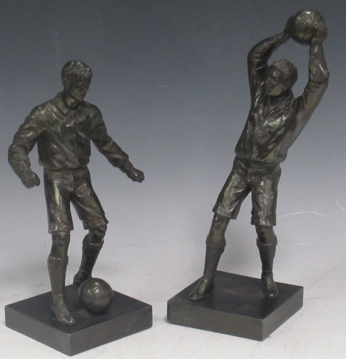 Two bronzed metal footballer figures, 34cm high