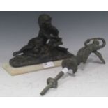 A bronze sculpture of a reclining figurer reading, approx. 17 x 23cm; together with a further cast