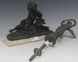 A bronze sculpture of a reclining figurer reading, approx. 17 x 23cm; together with a further cast