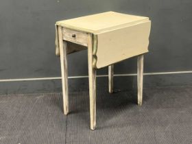 A white painted pembroke table the shaped hinged top over a single frieze drawer on tapered legs
