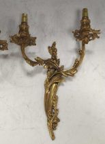 A pair of gilt metal Rococo style wall lights total height 36cm; 27cm wide; back plate 30cm high