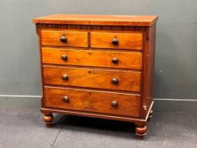 A late 19th century fruitwood chest of drawers, with two short over three long drawers flanked by