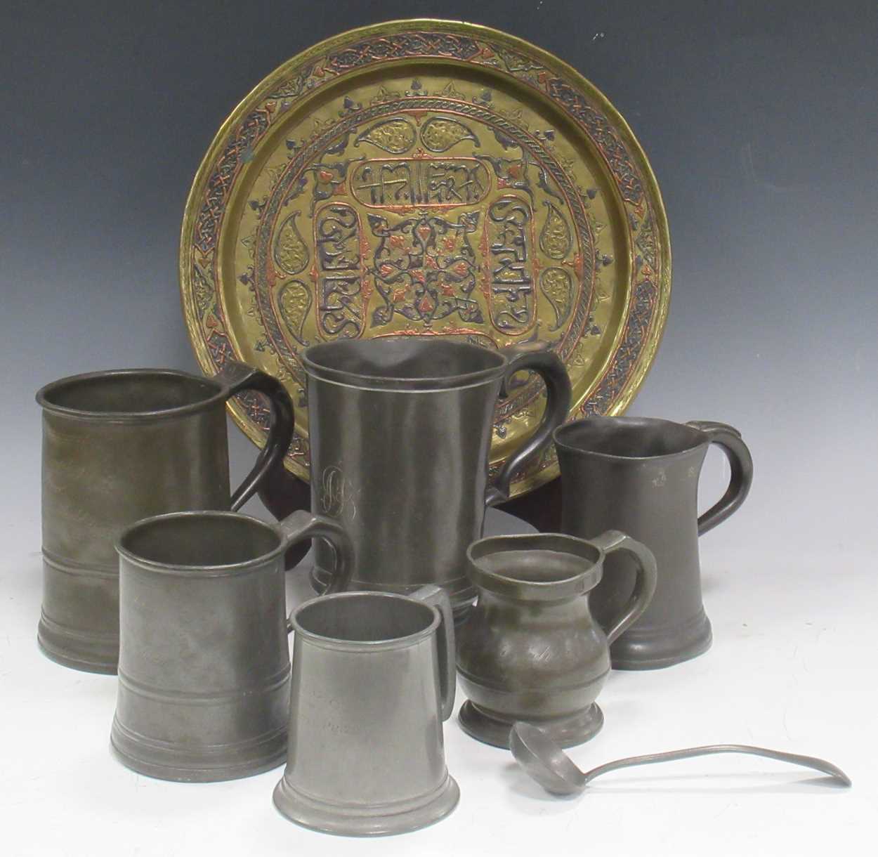 Six antique pewter mugs marked with standard measures, and a 'Damascus 1919' brass dish