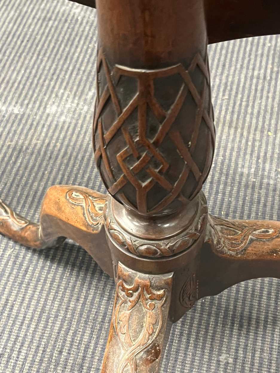 A mahogany snap top tripod table, with carved patterned shaped top on a baluster column and carved - Image 4 of 4