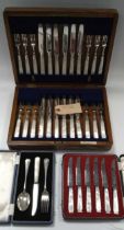 A cased set of twelve pairs of silver dessert knives and forks with mother-of-pearl handles,