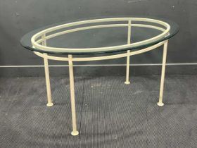 A painted metal table with oval glass top 76 x 152 x 106cm
