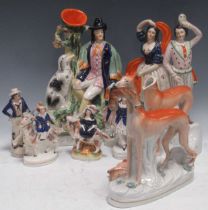 A collection of Staffordshire figures including a pair of greyhounds; a spill vase entitled Dog Tray