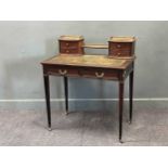 An Edwardian mahogany writting desks with blind fret carved drawers on tapered legs 94 x 84 x 51cm