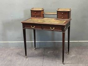 An Edwardian mahogany writting desks with blind fret carved drawers on tapered legs 94 x 84 x 51cm