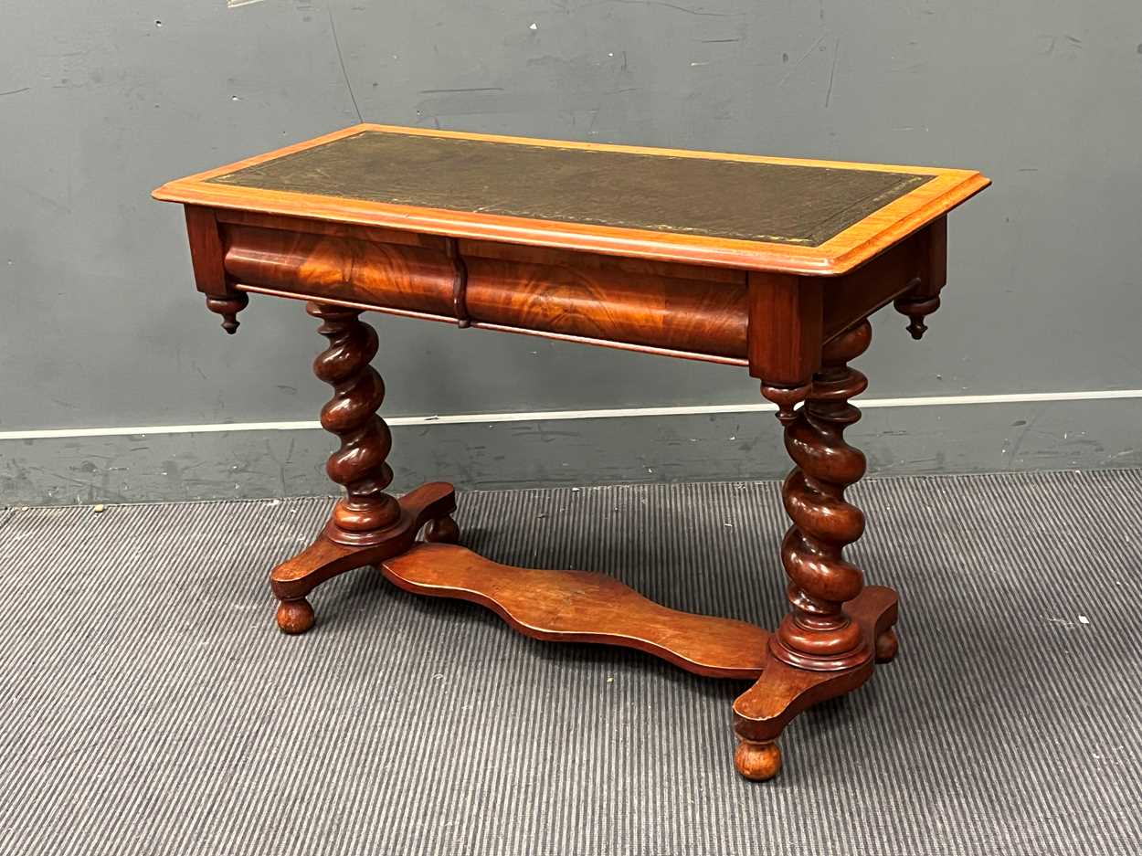 A late Victorian mahogany writing table with tooled leather top on barley twist supports 70cm x