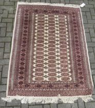 Sand colour ground rug with brown repeating medallions 187 x 130cm