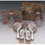 A silver and floral enamelled dressing table set, two silver topped lass scent bottles, a floral