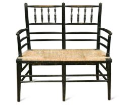 Attributed to Morris & Co., an ebonised wood two-seat settle,