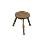 § Attributed to Arthur W. Simpson (1857-1922) of Kendal, a carved oak milking stool,