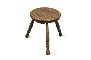 § Attributed to Arthur W. Simpson (1857-1922) of Kendal, a carved oak milking stool,