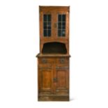 Liberty & Co., an Arts & Crafts oak narrow bookcase cabinet,