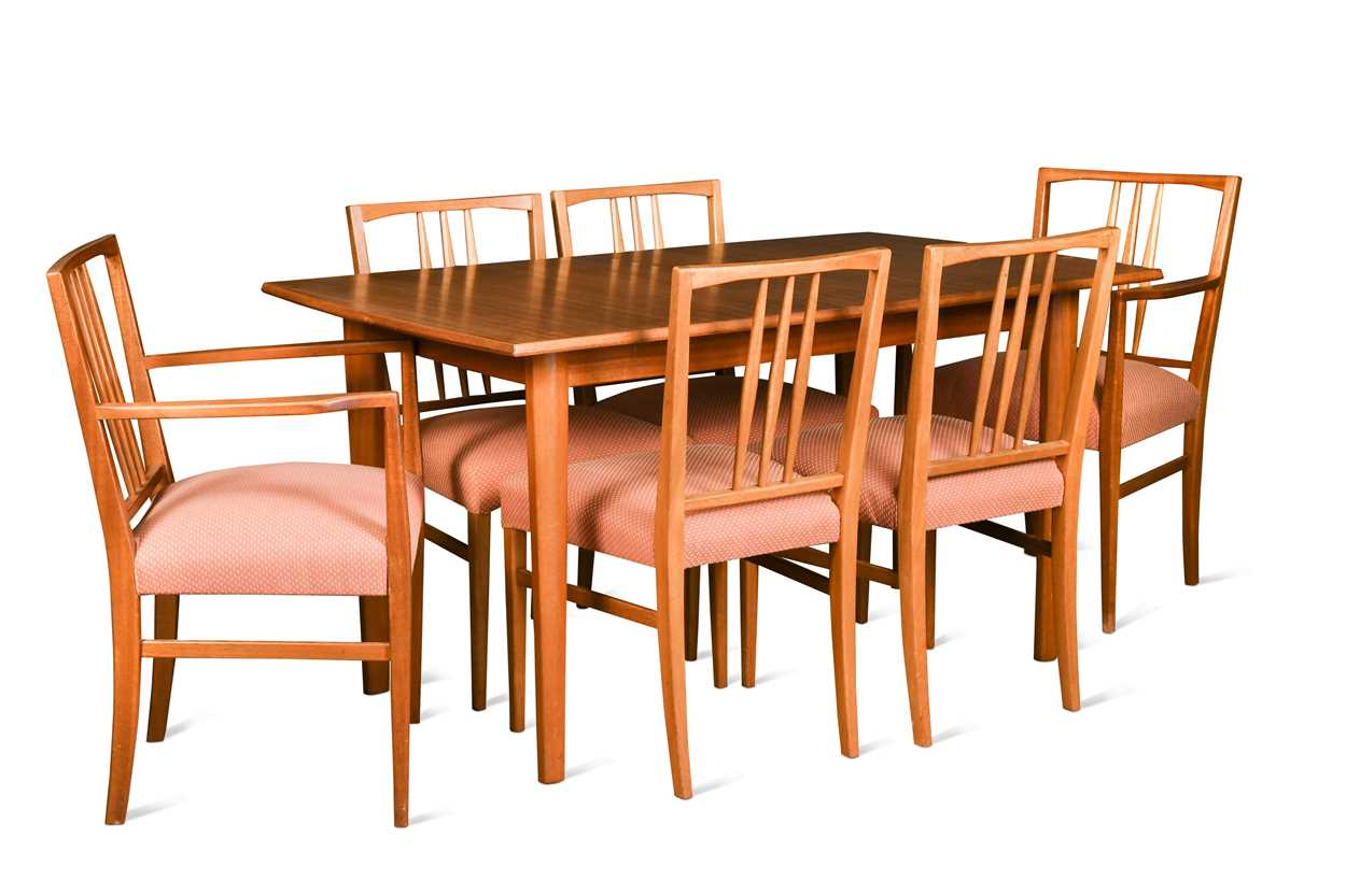 Gordon Russell, a walnut and teak extending dining table and eight chairs,