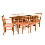 Gordon Russell, a walnut and teak extending dining table and eight chairs,