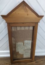 An early 20th century pine ecclesiastical style glazed Noticeboard, W 56 cm x H 98 cm x D 7 cm.