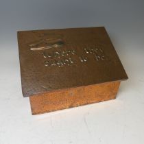 A copper covered Arts and crafts slipper Box, the hinged lid designed with a pair of slippers in