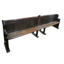 A large oak Victorian double church Pew, decorated with carvings and scrolls, constructed from two