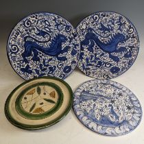 A pair of antique blue and white pottery Wall Plates, decorated with central animal enclosed with