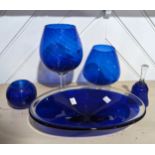 An antique large blue glass brandy Balloon, together with another similar, a blue glass Dish,