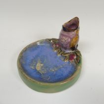 A Doulton Lambeth salt-glazed Bibelot, modelled as a Sparrow Chick with its beak agape, perched at