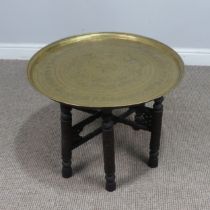 A Persian circular brass folding 'Benares' tray Table, W 57 cm x H 45 cm x D 57 cm, together with