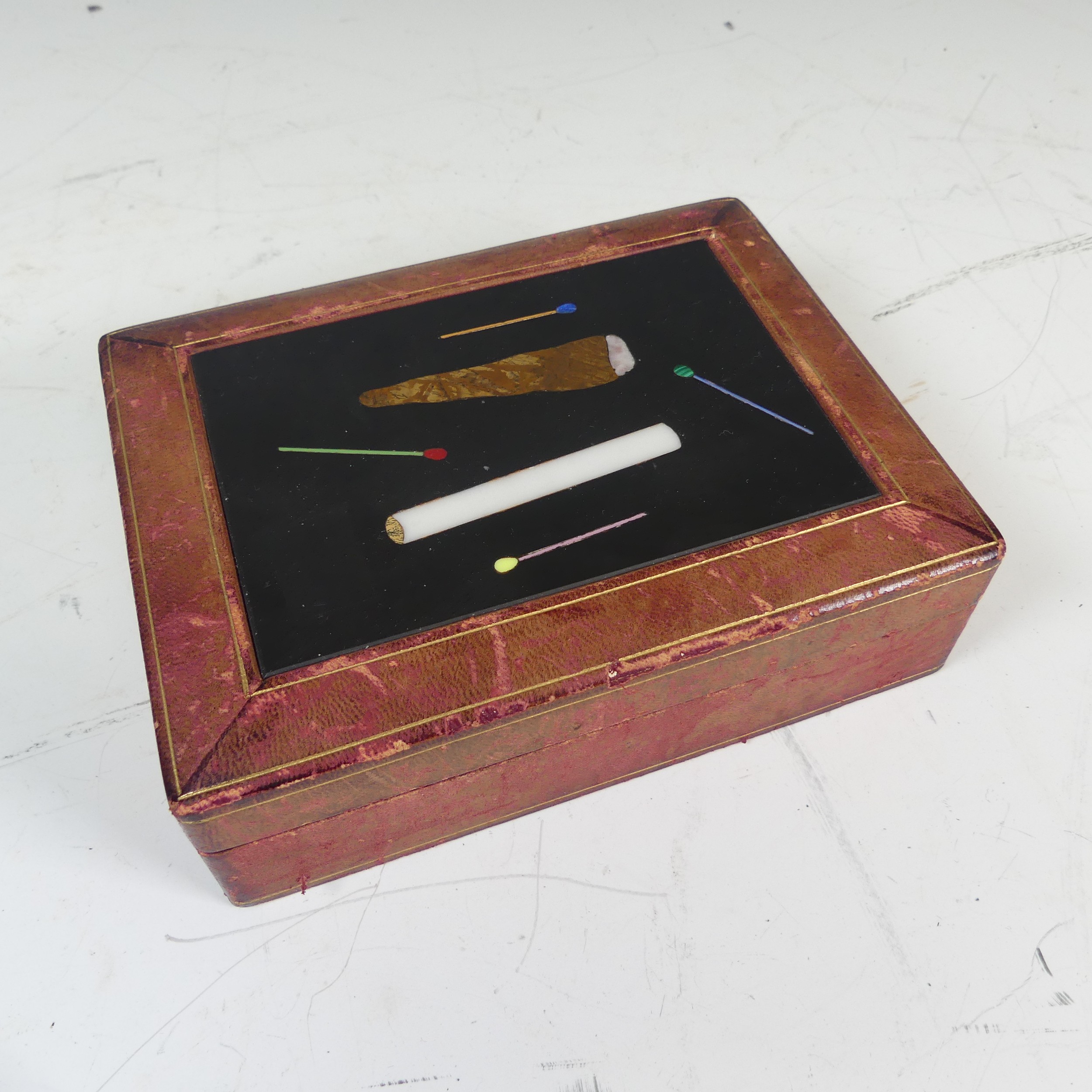 An Italian specimen stone and marble inset leather cigarette Box, W 17 cm x H 5 cm x D 13 cm.