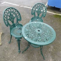 A green-painted cast metal circular garden Table and two Chairs, with pierced design, (Table) W 61