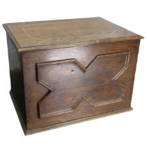 An antique oak kindling Box, with hinged lid and raised front panel, W 54 cm x H 37 cm x D 40 cm.