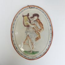 An early 19thC pearlware wall Plaque, depicting a classical figure, possibly Erato, in moulded