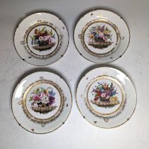 Attributed to Nantgarw: a set of four circular porcelain plates, each painted with a basket of