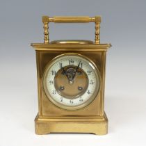 A large French brass carriage Clock, the dial centre inset with the visible lever escapement
