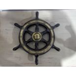 An antique oak and brass Ships Wheel, by Simpson & Lawrence, diameter 47 cm.