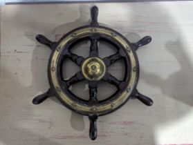 An antique oak and brass Ships Wheel, by Simpson & Lawrence, diameter 47 cm.