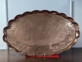 An Arts and Crafts Herbert Dyer cooper oval Tray, with scalloped rim and hammered surface embossed