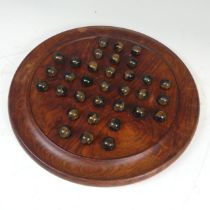 A vintage Solitaire Board, complete with Marbles.