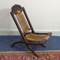 An Anglo-Indian folding Childs Chair, with carved hardwood frame and caned back and seat, W 36.5